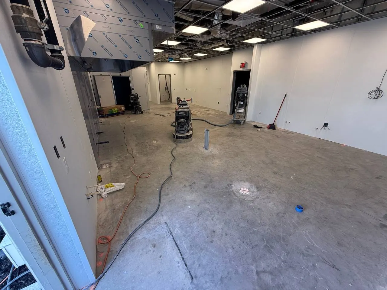 Restaurant kitchen build-out BEFORE — bare concrete slab Naples FL