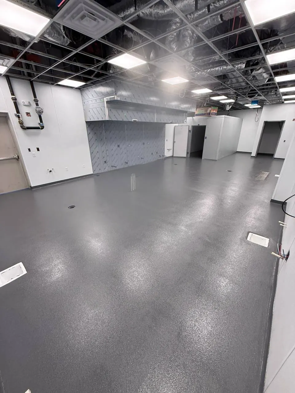 Restaurant kitchen build-out AFTER — finished quartz floor Naples FL