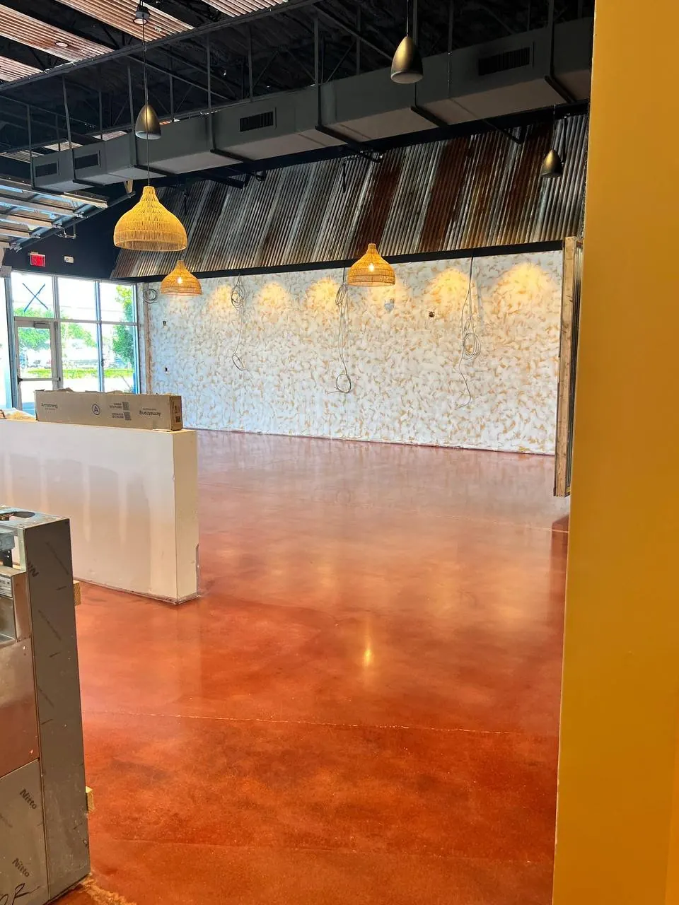 Polished concrete burgundy stain dining area Naples FL restaurant — hero shot